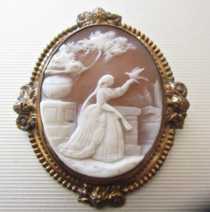 Superiorly carved woman at the vase with the bird. Circa 1880. Big Gold plated or GF Brooch. Signed by the Artist