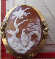 Victorian landscape - women at tree, bridge & houses on the horizon. Gold filled (plated?) brooch with floral decorations circa 1890.