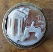 Girl on the town bridge - Sardonyx shell landscape . Gold filled brooch. Circa 1880.
