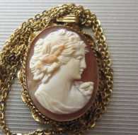 From 1920th great hand carved shell girl‘s profile Marked Gold filled pendant. Signed by the Artist