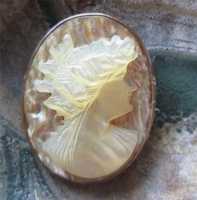 High relief girl’s profile - hand carved mother pearl from 1910th . Gold or Gold plated brooch.