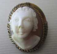 Hand carved straight face portrait of kid portrait shell from 1910th. Gold filled brooch/pendant.