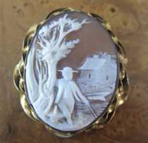 Carved scene of the man walking in the woods at the house and lake Light shell in the twisted Gold filled Brooch Circa 1895