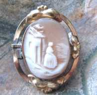Victorian, circa 1880 shell scene with women at the house Gold gilded leaves decorations bezel brooch.