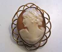 Great hand carved shell depicts a woman from 1920th - 1930th Marked filigree Gold filled Brooch/Pendant.