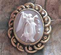 Carved Victorian Sardonyx shell woman flying with a kid & flowers Swinging Gold plated/pinchbeck brooch. Circa 1885.
