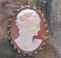 Signed by the Artist 1920-1950 hand carved Beauty profile shell. Unmarked Gold(?)/Gold plated twisted rope pendant.