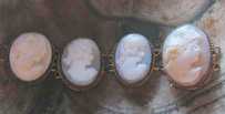 4 hand carved light shells - girlish profiles. Unmarked Gold Filled parts of bracelet circa 1920-1930.