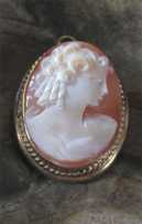 Hand carved Carnelian shell - 1930th girlish profile. Set in hallmarked Gold Filled pendant/brooch.