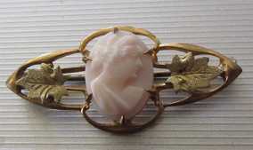 Edwardian circa 1910 carved Coral in Art Deco filigree leaves ornament Gold washed on brass Brooch.