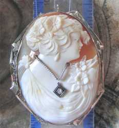 Well hand carved Art Deco shell with diamond brooch circa 1930 In the hallmarked filigree 14K White Gold Brooch/Pendant.