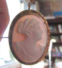 Edwardian hand carved high relief Coral stone from 1910-1920. Hallmarked 10K Yellow Gold etched brooch/pendant.