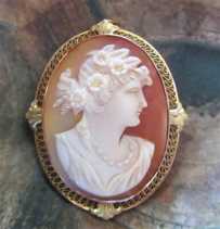 Hand carved & signed shell profile of woman with a flowers in her hair. Set in marked 10K Yellow Gold Brooch/Pendant 1925 - 1945.