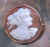 Greatly carved shell - profile of woman with a flowers in her hair. Set in unmarked/tested 10K+ Yellow Gold Brooch 1915 - 1930.