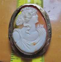 Hand carved/traced on right side shell profile of Victorian Beauty. Set in marked 10K Yellow Gold Brooch/Pendant 1890-1910.