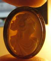 Late Victorian Brooch. Deep relief carving Angel Skin Coral from circa 1890. Marked 10K Yellow Gold