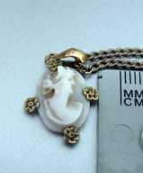 Marked 10K Yellow Gold Bezel Cameo with a pearls circa 1910. With Gold filled chain