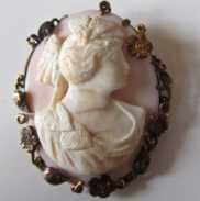 Hand carved Coral stone cameo from end of XIX or beginning of XX centuries In intricate low carat Yellow Gold floral brooch. Signed by the Artist.