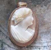 Petite high relief carved conch shell from 1905-1910 Marked 10K Yellow Gold pendant