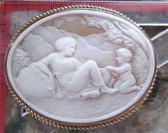 Huge remarkably carved composition of Cupid feeding Venus. Shell in the 375 Marked Gold brooch/pendant.