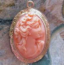 Quality carved Red Salmon Coral stone high relief Bacchante’s head In the marked 10K Yellow Gold circa 1900-1910 Pendant/Brooch