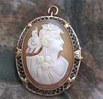 Circa 1890 Art Deco woman profile - hand carved Carnelian shell. In the marked 10K Yellow Gold filigree Brooch/Pendant.