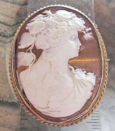 Museum Quality Victorian/Edwardian Circa 1905 Bacchante image Marked 9K Yellow Gold brooch/pendant with security chain .
