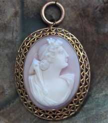 Greatly carved high relief Coral circa 1895 Goddess Amphitrite Marked 10K Yellow Gold filigree Gold brooch/pendant.