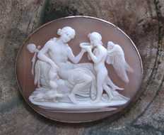 Amazing Victorian shell depict of Bacchante giving vine to Eros Unmarked/tested 14 Karat Yellow Gold brooch/pendant.