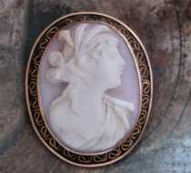 Victorian/Edwardian high relief carved Angel Skin Ceres Goddess Marked 10K Yellow Gold filigree brooch. Signed by the Artist