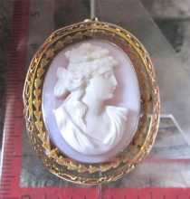 Victorian high relief 1895, carved Angel Skin Coral. Signed by the Artist Hallmarked 10K Yellow Gold filigree brooch/pendant.