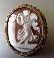 Scene of Muse playing Lira Sardonyx Shell circa 1910 Marked 800 Silver bezel covered by Gold Vermeil Brooch/Pendant