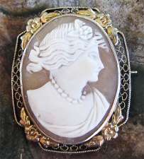 Nice carved image of young woman circa 1940 Silver with Gold flower bezel Brooch