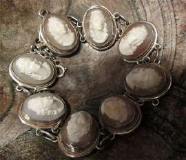 Hand carved 8 pretty heads from Carnelian shell circa 1940th, marked 800 Silver Bracelet.