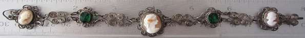 3 carved Sardonyx shell with Oz. or green rhinestones. in unmarked silver color filigree Bracelet