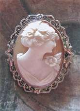 Circa 1930-1945 well hand carved shell Signed by the Artist. Marked sterling silver filigree brooch. USA