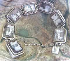 Monumentally carved Light on Dark Mother of Pearl stones 7 Mythology scenes in 900 Silver Bracelet with chain. Circa 1930th