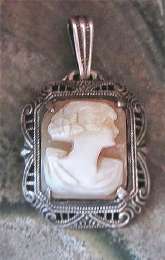 Art Deco 1915-1925 well hand carved shell Signed by the Artist. Marked sterling silver filigree little beauty pendant.