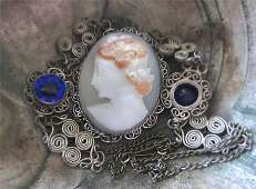 Circa 1930 hand carved Classic Multicolor profile shell. Signed. Unmarked Silver pendant with the 14”chain & 2 bright blue stons.